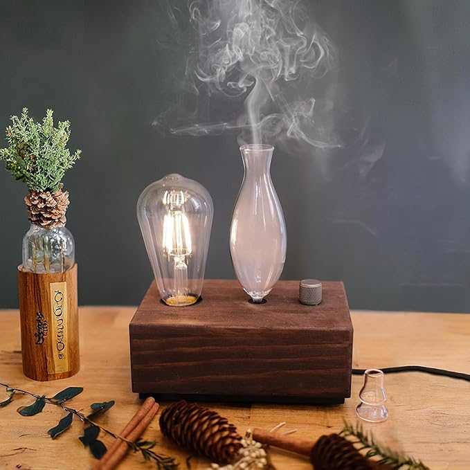 Wood and glass waterless aromatherapy diffuser with walnut base and glass reservoir releasing essential oil mist