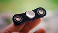 Fidget spinner held between fingers
